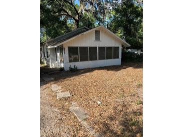 View of exterior showing the front of the home with a yard covered in leaves at 5429 Vanderlin St, Orlando, FL 32810