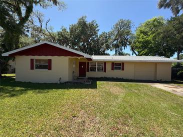 Charming one-story home with a well-maintained lawn and mature trees providing ample shade at 1818 Mango Tree Dr, Edgewater, FL 32132
