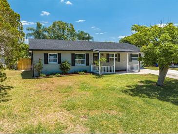 Charming single-story home featuring a well-maintained lawn and inviting front porch at 219 Vermont Ave, St Cloud, FL 34769