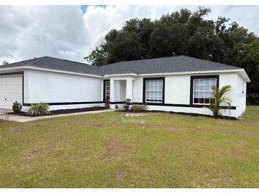 Charming one-story home with a well-maintained lawn, fresh exterior paint and an inviting entrance at 5356 Spivey Glen Ct, Lakeland, FL 33810