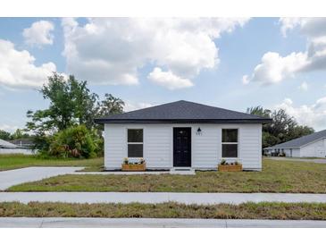 Charming single-story home featuring a freshly painted exterior, a modern roof and landscaped front yard at 991 Polk St, Bartow, FL 33830