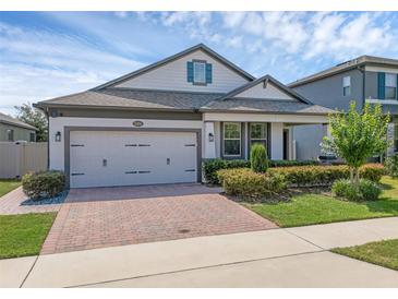 Beautiful home featuring a brick driveway and a well-maintained front yard with lush landscaping at 1896 Napoli Dr, St Cloud, FL 34771