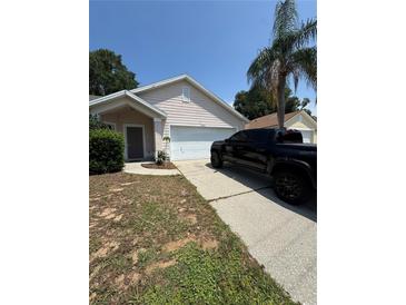 Charming single-story home features an attached garage, front yard, and a driveway with parking at 294 Lake Doe Blvd, Apopka, FL 32703
