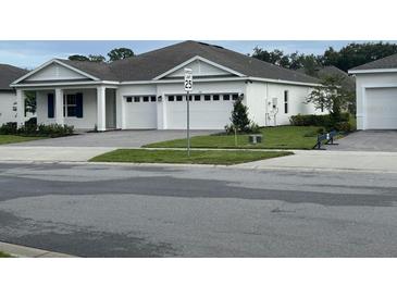 Charming single-story home featuring a three-car garage, manicured lawn and meticulous landscaping at 742 Copper Creek Dr, New Smyrna Beach, FL 32168