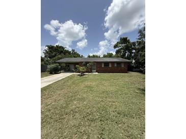 Charming single-story brick home with a well-maintained lawn, ready for your personal touch at 1516 Avenue D Ne, Winter Haven, FL 33881