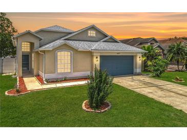 Charming single-Gathering home featuring well-maintained landscaping, a two-car garage, and a neatly manicured lawn at 1437 Abberton Dr, Orlando, FL 32837