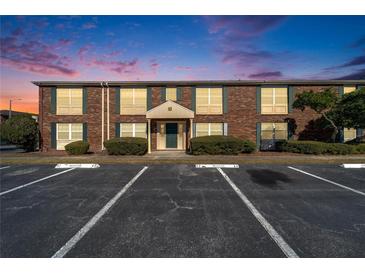 Brick building exterior with parking lot and landscaping at 1920 E Edgewood Dr # A4, Lakeland, FL 33803