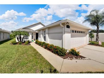 Single-story house with attached garage, landscaping, and walkway at 2178 Sunstone Dr, Lakeland, FL 33813