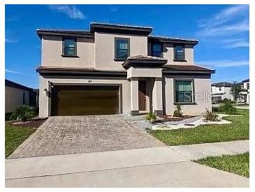 Two-story house with a large driveway and landscaped lawn at 187 Brooke'S Pl, Haines City, FL 33844