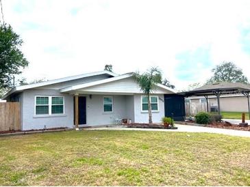 Charming single-story home featuring a well-maintained lawn and a covered carport at 3445 Avenue F Nw, Winter Haven, FL 33880