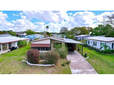 Charming single-story home with a well-maintained lawn and driveway at 470 Village Sw Cir, Winter Haven, FL 33880