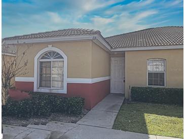 Charming one-story home featuring a well-maintained lawn and welcoming entryway at 184 Ocean Bluff Dr, Poinciana, FL 34759