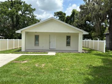 Charming single-story home featuring a quaint front porch and well-maintained lawn at 340 W Stanford St, Bartow, FL 33830
