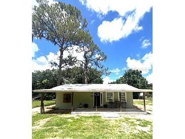 Charming single-story home with a covered porch, offering a cozy and inviting exterior at 4140 Old Dixie Hwy, Auburndale, FL 33823