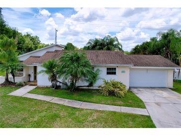 Charming single-story home with lush landscaping and attached two-car garage at 4966 Foxrun Ln, Lakeland, FL 33813