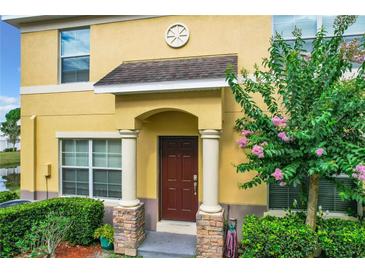 Inviting home entrance featuring a covered porch with decorative columns and a well-manicured garden at 519 Sandstone St, Lakeland, FL 33809