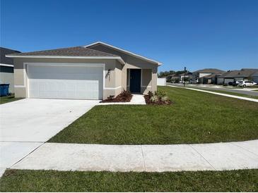 Charming single-story home with a well-manicured lawn and attached two-car garage at 2203 Majestic Span Ave, Eagle Lake, FL 33839
