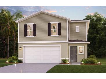 Two-story house with a neutral color scheme, attached garage, and landscaping at 1041 Ambleside Dr, Haines City, FL 33844