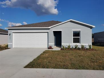 Charming single-story home with a one-car garage and neatly landscaped front yard at 13001 Se 53Rd Ave, Belleview, FL 34420