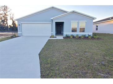 New single-story home with attached garage and landscaped front yard at 12966 Se 53Rd Ave, Belleview, FL 34420