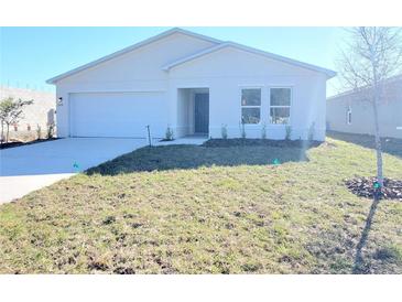 New construction home featuring a two-car garage and minimalist landscaping at 2491 Nw 23Rd Ave, Ocala, FL 34475