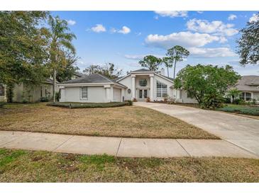 House exterior featuring a two-car garage and manicured lawn at 388 Hampton Hills Ct, Debary, FL 32713