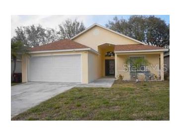 One-story house with attached garage and landscaped lawn at 2325 Paulette Dr, Haines City, FL 33844