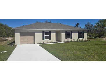 Charming one-story home with a well-manicured lawn and neutral color palette at 422 St Johns Ln, Poinciana, FL 34759