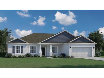 Charming single-story home featuring a well-manicured lawn, attached two-car garage, and a classic architectural design at 16446 Sw 47Th Ct, Ocala, FL 34473