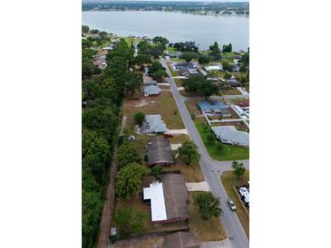 Expansive aerial view showcases neighborhood homes near the tranquil lake at 5801 Poinciana Ave, Lakeland, FL 33809