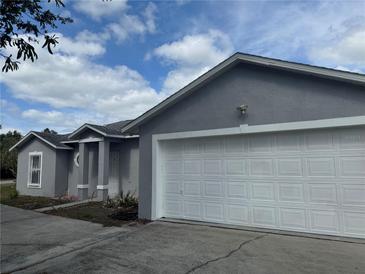 Charming single Gathering home with a two car garage and light-grey colored stucco siding at 1152 Mccormick Dr, Deltona, FL 32725