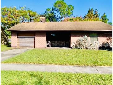 Single-story home featuring a one-car garage, neutral color palette, and a well-maintained green lawn at 7639 Panthera Ct, Orlando, FL 32822