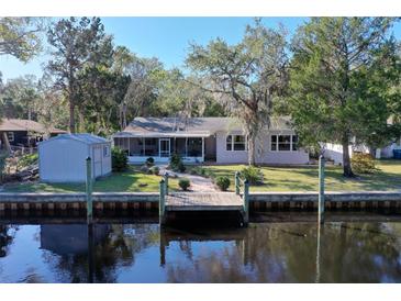 Charming home with a spacious backyard, private dock, and shed at 1069 Indigo Rd, Ormond Beach, FL 32174