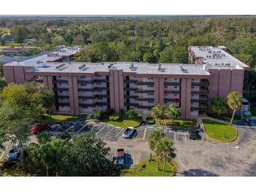 Aerial view of Tomoka Oakwood North condos, showing building and parking lot at 640 N Nova Rd # 212, Ormond Beach, FL 32174