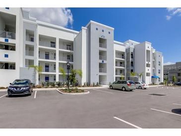 Modern apartment building with parking and landscaped grounds at 4741 Clock Tower Dr # 105, Kissimmee, FL 34746