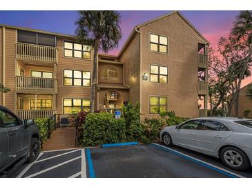 Two-story condo building with ample parking and lush landscaping at 1401 S Palmetto Ave # 618, Daytona Beach, FL 32114