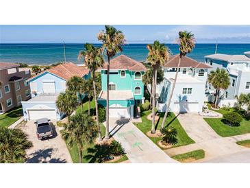 Coastal community home with ocean views and palm trees at 166 Coquina Key Dr, Ormond Beach, FL 32176