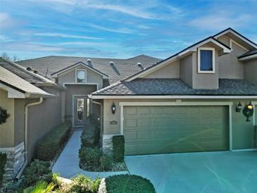 Two-story house with a two-car garage and landscaped walkway at 1311 Hansberry Ln, Ormond Beach, FL 32174