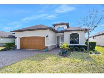 Beautiful one-story home with a two-car garage and landscaped yard at 3189 Connemara Dr, Ormond Beach, FL 32174