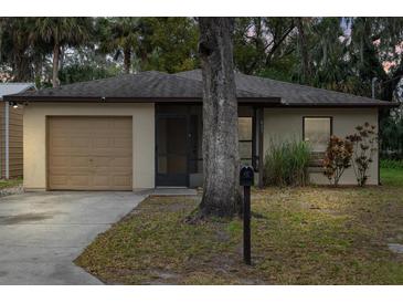 Tan house with a brown garage door and small front yard at 627 Clark St, Daytona Beach, FL 32114