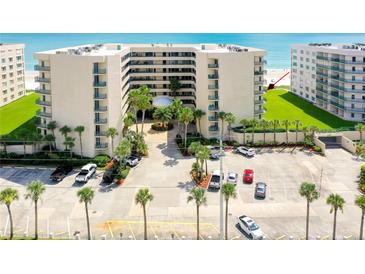 Oceanfront condo building with parking and lush landscaping at 4565 S Atlantic Ave # 5411, Ponce Inlet, FL 32127