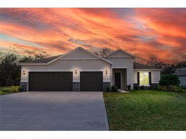 Charming one-story home with a three car garage and beautiful stone accents at 3142 Silvermines Ave, Ormond Beach, FL 32174