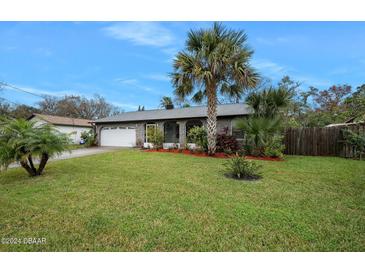 Inviting home exterior featuring a spacious lawn and lush landscaping at 41 Laurel Oaks Cir, Ormond Beach, FL 32174