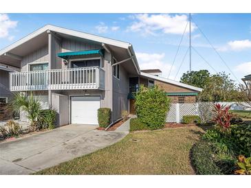 Two-story townhome with attached garage and balcony at 135 Lagoon Ct, New Smyrna Beach, FL 32169