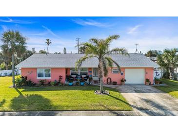 Charming single-story home with a well-manicured lawn, a palm tree, and a cozy front porch at 100 Lynnhurst Dr, Ormond Beach, FL 32176