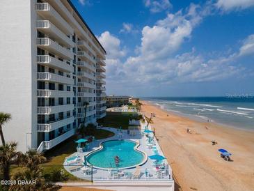 Oceanfront condominium complex with an outdoor pool and beach access at 1575 Ocean Shore Blvd # 205, Ormond Beach, FL 32176