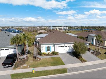 Beautiful single-story home featuring a manicured lawn, two car garage, and paver driveway at 243 Island Breeze Ave, Daytona Beach, FL 32124