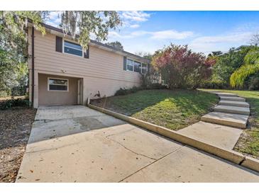 Charming home exterior with a quaint yard and concrete driveway on a sunny day at 630 W Rich Ave, Deland, FL 32720