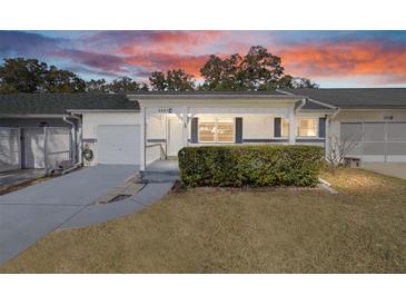 Charming single story home with well maintained landscaping and inviting front porch at sunset at 8885 Sw 95Th St # C, Ocala, FL 34481