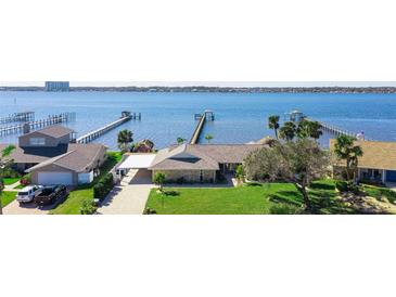 Waterfront home with private boat docks, lush landscaping, and a convenient carport at 2912 River Point Dr, Daytona Beach, FL 32118